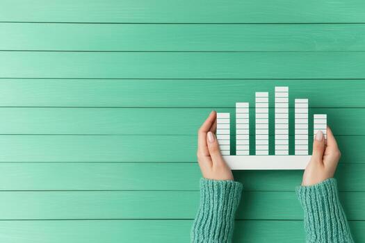 Hands holding chart showing financial growth and trends photo