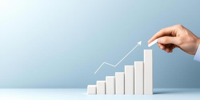Growth chart showing upward trend with hand on blue background photo