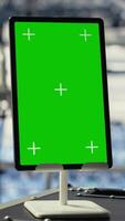 Vertical Close up shot of green screen tablet in data center with advanced technology workloads. Mockup chroma key device in server farm with high tech infrastructure, panning shot video