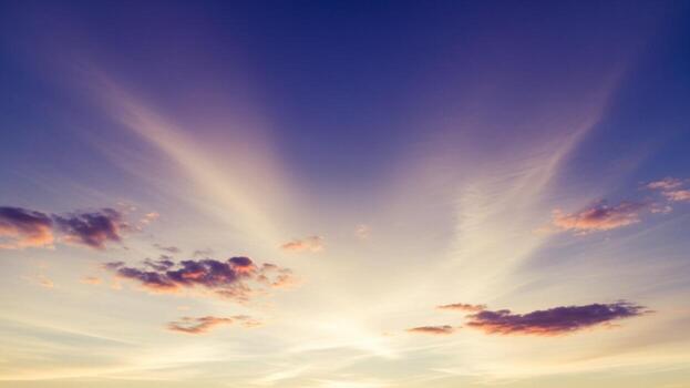 A sunset with clouds and sunbeams photo