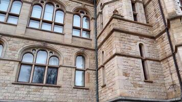 The building has arched windows and a clock on video