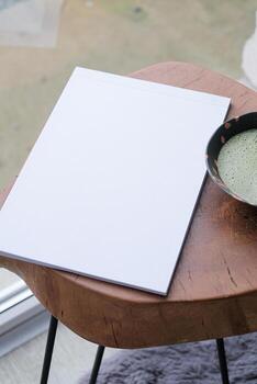 magazine mockup on table with matcha tea near window photo