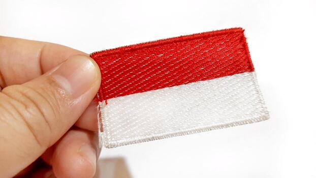 Indonesian Flag Patch Held in Hand photo