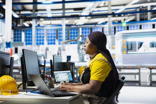 Solar panel factory engineer designing CAD models and technical sketches for alternative energy systems on laptop. Woman worker ensures photovoltaics design for efficiency and innovation. photo