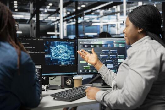 Data center engineering team talking in office, using artificial intelligence computerized model. Teamworking server room colleagues working with AI machine learning algorithms photo
