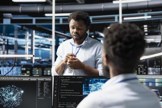 Data center software developers using machine learning algorithms to analyze large datasets. Server farm workplace colleagues cooperating, using artificial intelligence to recognize data patterns photo