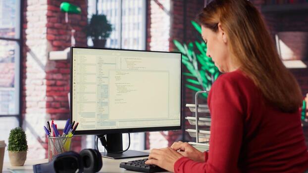 Woman engaging with an intelligent AI chatbot to complete work related tasks, working from loft apartment. Technology showcases machine learning and smart algorithms for productivity. Camera A. photo