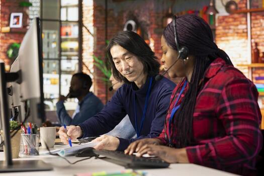 Call center managers developing strategies to improve customer loyalty, looking over paperwork. Customer support management team implementing procedures for better client issue resolution photo