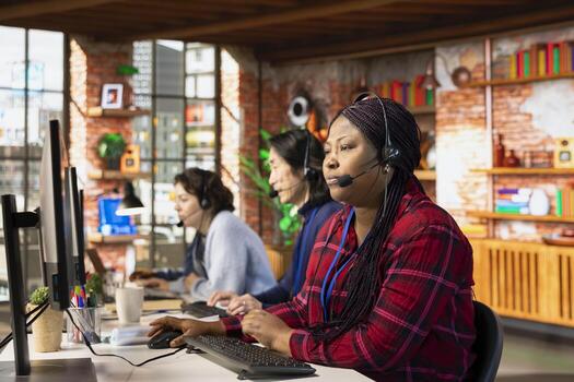 Multiethnic team of call center agents answering clients technical inquiries about hardware issue. Multiracial customer support workers in office doing job using PC to troubleshoot problems photo