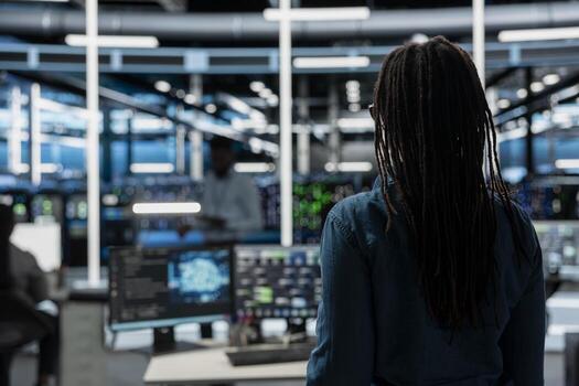 System administrator entering data center office, preparing to use artificial intelligence computerized model. Server room employee arriving at work, starting job shift, using AI photo