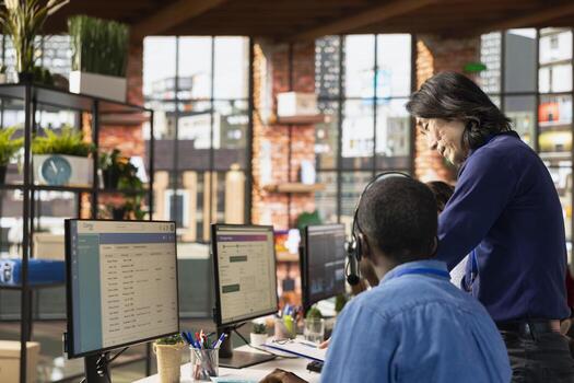 Call center supervisor checking progress done by agents investigating lost clients packages in office. Customer support manager supervising staff members using program on PC to locate clients parcels photo