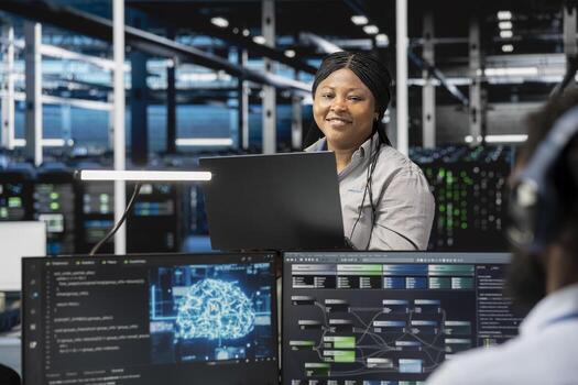 Portrait of smiling software developer working in data center with artificial intelligence tech to process massive datasets. Happy IT professional in server hub storing data used for deep learning photo