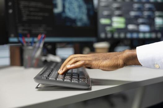 Close up of engineer typing on keyboard, doing maintenance on server hub to optimize it for artificial intelligence workloads. Technician using PC, inspecting neural network data center photo