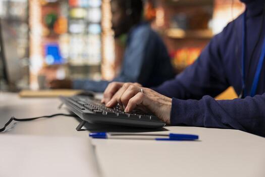 Call center agent typing on keyboard, using remote access tools to connect to customer devices remotely for troubleshooting. Customer center employee using PC to assist users with installing software photo