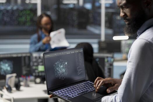Data center admin using artificial intelligence visualization tools on laptop to identify equipment errors. Server hub worker looking at insights on notebook to detect hardware failures photo