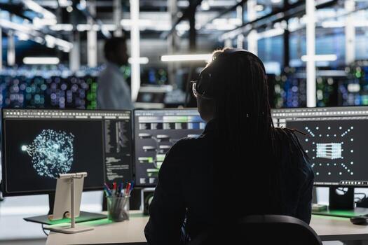 Data center admin uses AI visualization tool on PC to optimize resource allocation. Server farm employee uses artificial intelligence analysis software on computer to do maintenance photo