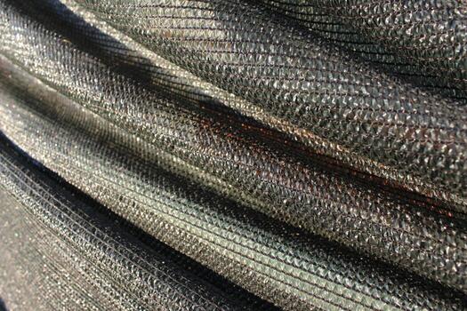 dark background with folds of shading facade mesh photo