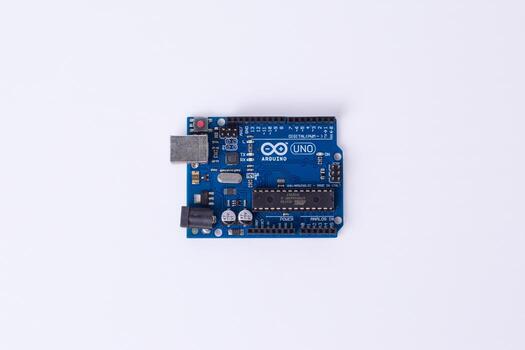 Malang, March 24, 2025. Top view of Arduino Uno microcontroller board on white background. DIY electronics, robotics, embedded system, prototyping hardware, open-source platform photo