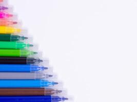 Colorful markers diagonally neatly arranged on white background with copy space. Set of rainbow felt-tip pens for kids art, drawing, coloring, and creative education. photo