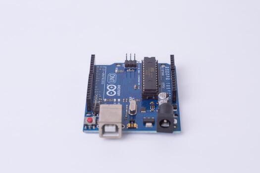 Malang, March 24, 2025. Front view of Arduino Uno microcontroller board on white background. DIY electronics, robotics, embedded system, prototyping hardware, open-source platform for coding. photo