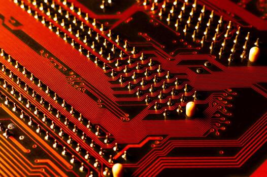 Circuit board with electronic components. Close-up of the components of the electronic circuit board, highlighted in red, with shallow focus. Ideal for backgrounds with technology-related themes photo