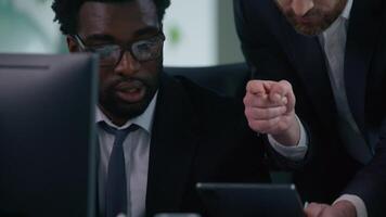 Diverse business team problem meeting in office arguing talking irritated multiracial partners three co-workers trouble documents computer work digital tablet data misunderstanding job mistake argue video