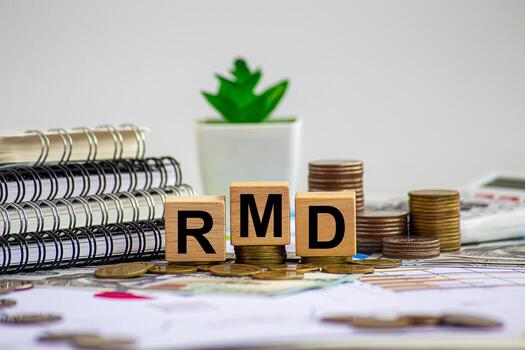 Required Minimum Distribution RMD Concept Represented by Wooden Blocks on Financial Document Background photo