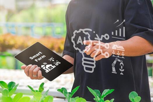 Agricultural technology concept, Ai system. A young man is working on a farm using a tablet controller with innovative technology for a smart farm system. photo