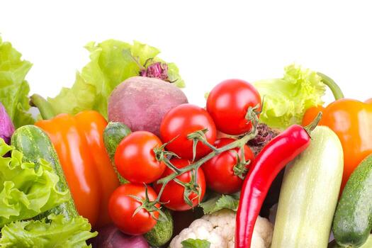 Many different vegetables including beets, cabbage, zucchini, carrots, tomatoes, peppers and cucumbers on a white background. isolated. top view photo