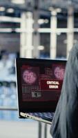 Vertical Server hub programmer alerted by warning message about bugs causing infrastructure slowdowns. Data center IT expert sees system popup about low hardware performance caused by software bugs, camera B video