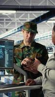 Vertical Army experts in server room use artificial intelligence program to review reconnaissance information. Military data center colleagues run machine learning systems to prepare missions, camera A video