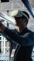 Vertical Data center employee check AI dashboard using VR headset during systems review. Server hub worker using virtual reality tech to test artificial intelligence tools for reliable performance, camera B video