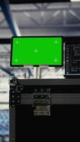 Vertical Green screen tablet in server room with equipment rigs supporting AI technology. Chroma key device in data center storing and processing vast datasets for artificial intelligence operations video