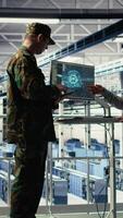 Vertical Server room army experts deploy AI tech to modernize defense infrastructure. Military server room colleagues enhancing tactical readiness by integrating artificial intelligence technology, camera A video