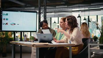 affärskvinna jämföra analys och planen strategi i en modern arbetsyta, stödjande utveckling syn tillsammans. olika medarbetare samarbetande och granskning data analyser. kamera a. video