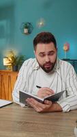 pov ordenador portátil ver de persona de libre dedicación hombre estudiar con cuaderno haciendo notas chico haciendo conferencia llamada hablando a cámara web se sienta a hogar oficina mesa. en línea educación e-learning en remoto charlar. vertical video