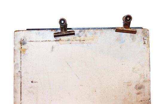 Vintage sketch board with two retro metal clips at the top, showing rust, stains, and age marks on a discolored surface. isolated on white background photo