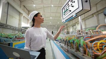 Female engineer working at programmable CNC machine in factory industries video