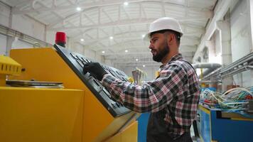 Engineer entering data in CNC machine at pvc window factory to get the production going video