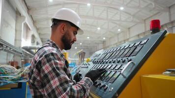 Engineer working at programmable CNC machine in factory industries video