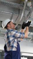 Technician installing air conditioning system in building video