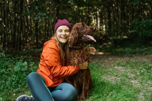 Laughing Woman Hugging Dog During Hike photo