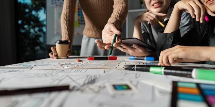 Creative UX UI Brainstorming Session with Designers Collaborating on Innovative Digital Solutions and User Experience Enhancements photo