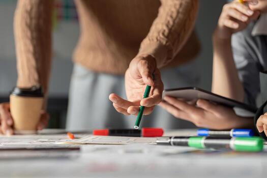 Team discussing UX UI strategies with sketches and digital tools in a workspace. photo