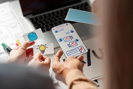 Creative team collaborating on UX UI design with wireframes and ideas. photo