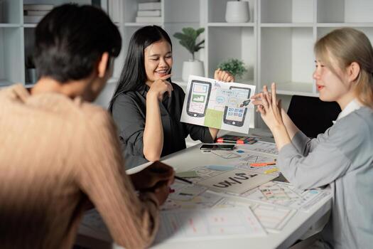 Designer showcasing UX UI concepts with prototypes during team discussion. photo