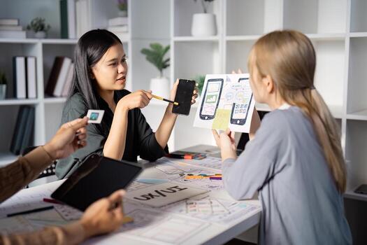 Engaging UX UI design discussion with mobile app prototypes and team feedback. photo