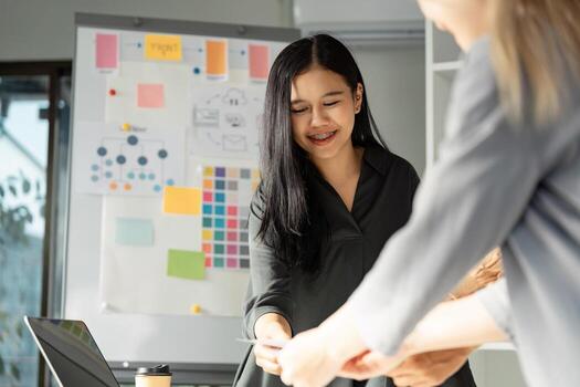 Enthusiastic UX UI design collaboration with team sharing ideas and visuals. photo