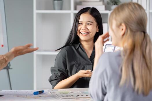 Joyful UX UI design collaboration with team members sharing ideas and feedback. photo