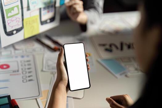 Creative UX UI Design Process with Mobile App Prototypes and Wireframes in Modern Office Setting photo